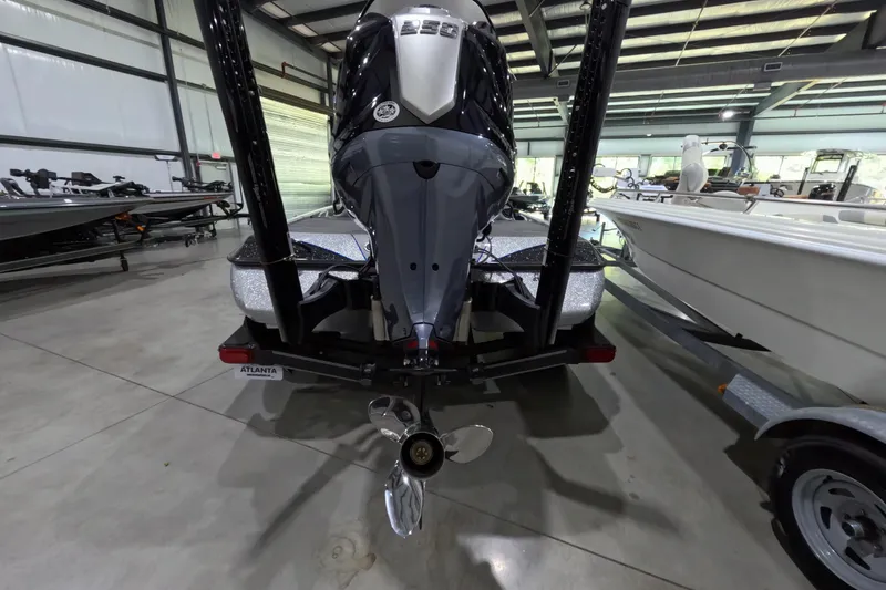 Slide: The Image of 2025 Skeeter boat in showroom, rear view with motor and propeller visible. - 9