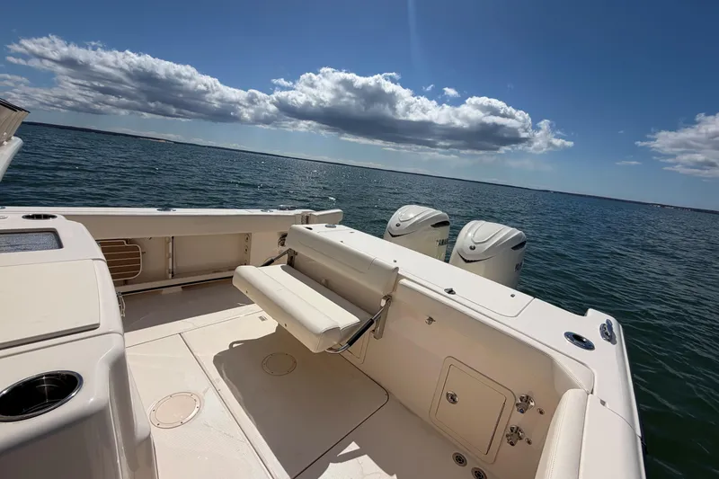 Slide: The Image of 2025 Grady-White Canyon 306 boat with dual engines on open water. - 15