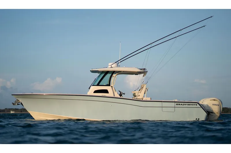Slide: The Image of 2025 Grady-White Canyon 306 boat on water, showcasing sleek design and twin engines. - 2