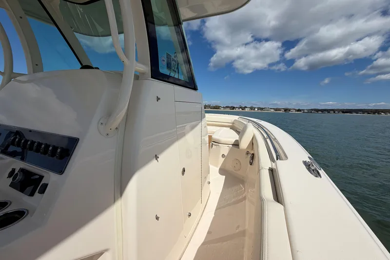 Slide: The Image of 2025 Grady-White Canyon 306 boat on water, showcasing sleek design and spacious deck. - 23