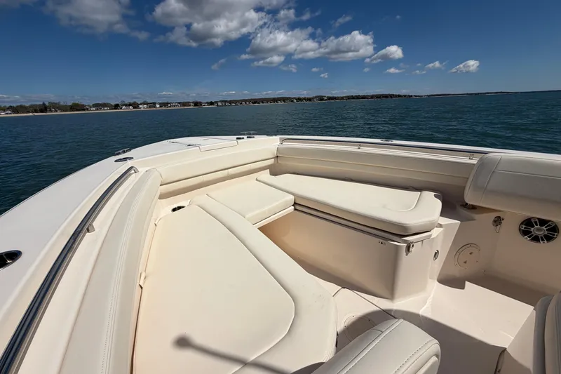 Slide: The Image of 2025 Grady-White Canyon 306 boat interior with cushioned seating on open water. - 26
