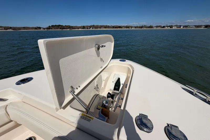 Slide: The Image of 2025 Grady-White Canyon 306 boat with open anchor hatch on calm water. - 28
