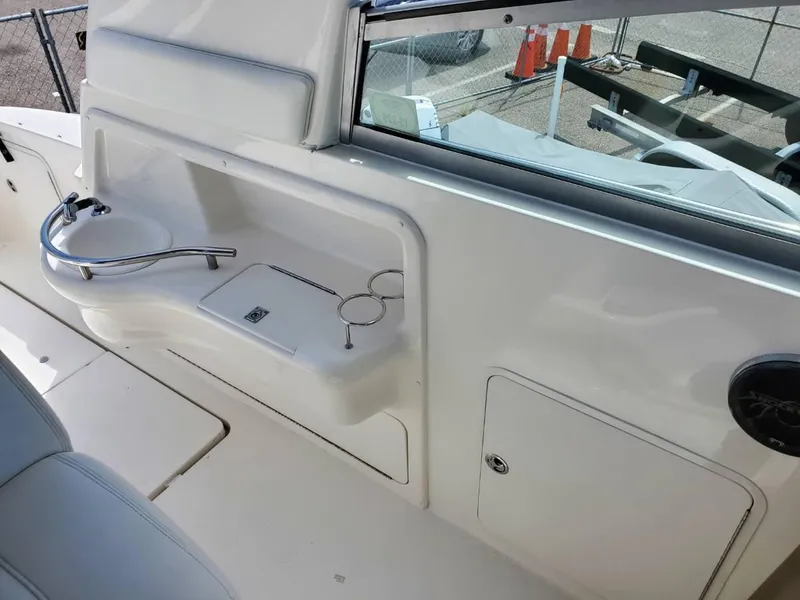 Slide: The Image of 2002 Sea Ray 310 Sundancer boat interior with sink and cup holders. - 10