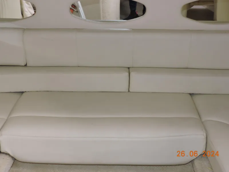 Slide: The Image of White leather seating on a 2002 Sea Ray 310 Sundancer yacht interior. - 13