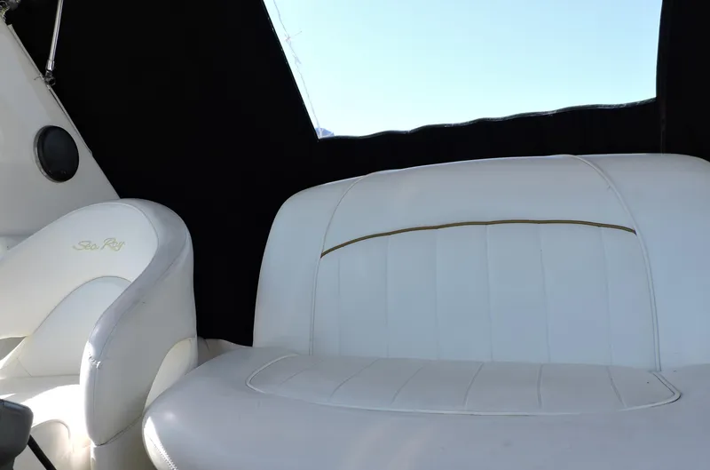Slide: The Image of White leather seating on 2002 Sea Ray 310 Sundancer boat interior. - 17