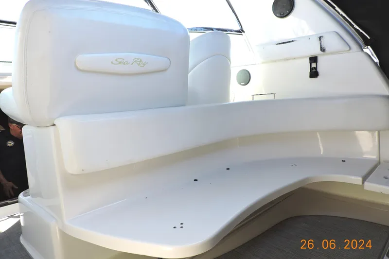Slide: The Image of 2002 Sea Ray 310 Sundancer boat interior with white seating and modern design. - 20
