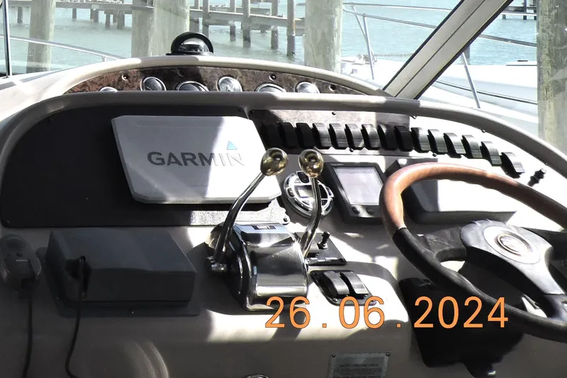 Slide: The Image of Control panel of a 2002 Sea Ray 310 Sundancer boat with Garmin navigation system. - 27