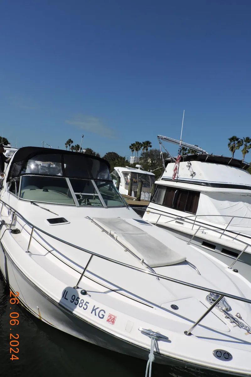 Slide: The Image of 2002 Sea Ray 310 Sundancer docked at marina under clear blue sky. - 3