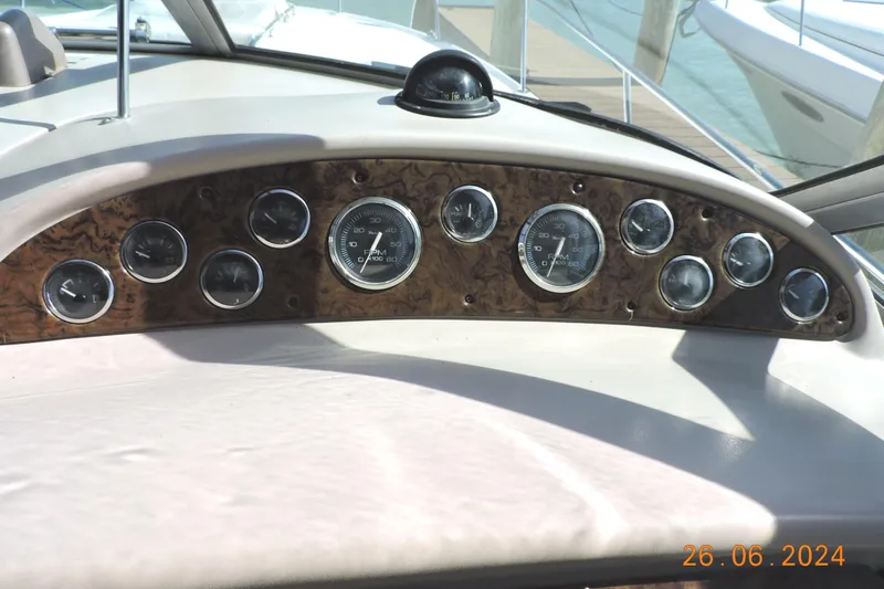 Slide: The Image of Dashboard of a 2002 Sea Ray 310 Sundancer boat with multiple gauges. - 30