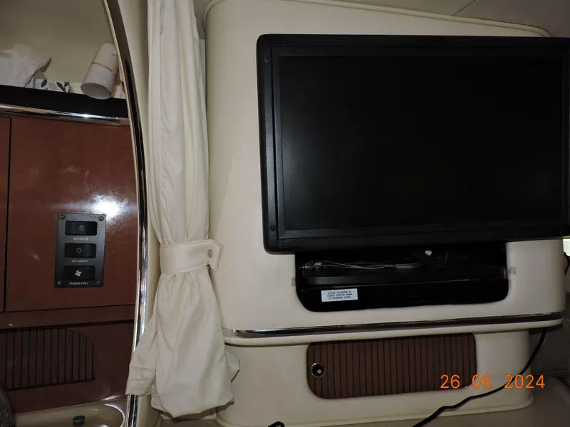 Slide: The Image of Interior of 2002 Sea Ray 310 Sundancer with mounted TV and control panel. - 31