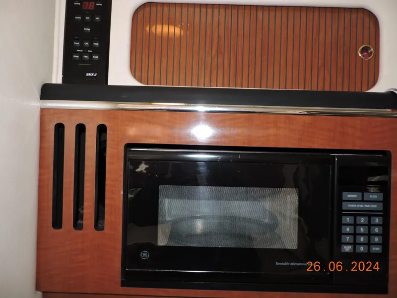 Slide: The Image of Microwave and control panel in 2002 Sea Ray 310 Sundancer boat interior. - 34