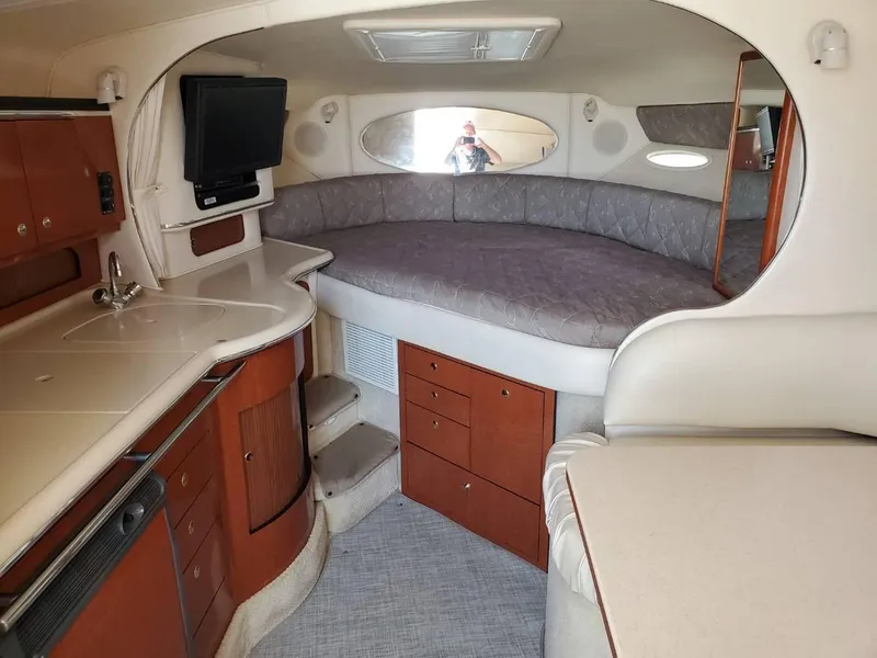 Slide: The Image of Interior of 2002 Sea Ray 310 Sundancer with kitchenette and cozy sleeping area. - 36