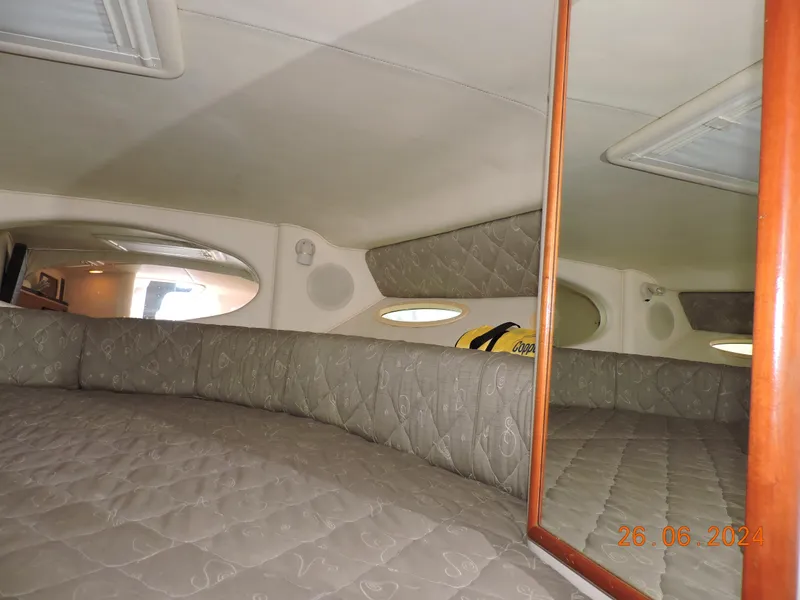 Slide: The Image of Interior cabin of 2002 Sea Ray 310 Sundancer with quilted upholstery and mirror. - 37