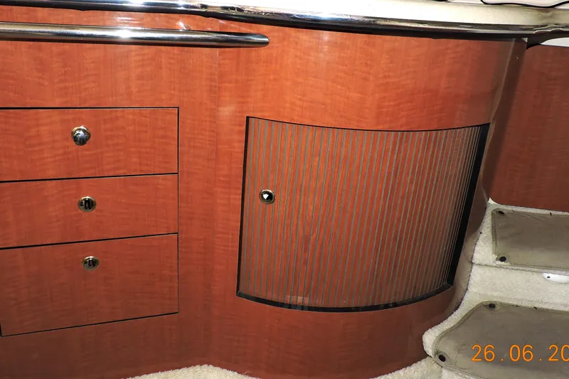 Slide: The Image of Interior cabinetry of 2002 Sea Ray 310 Sundancer, featuring wood finish and storage drawers. - 41