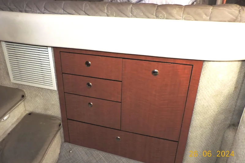 Slide: The Image of Interior cabin storage of 2002 Sea Ray 310 Sundancer boat with wooden drawers. - 42