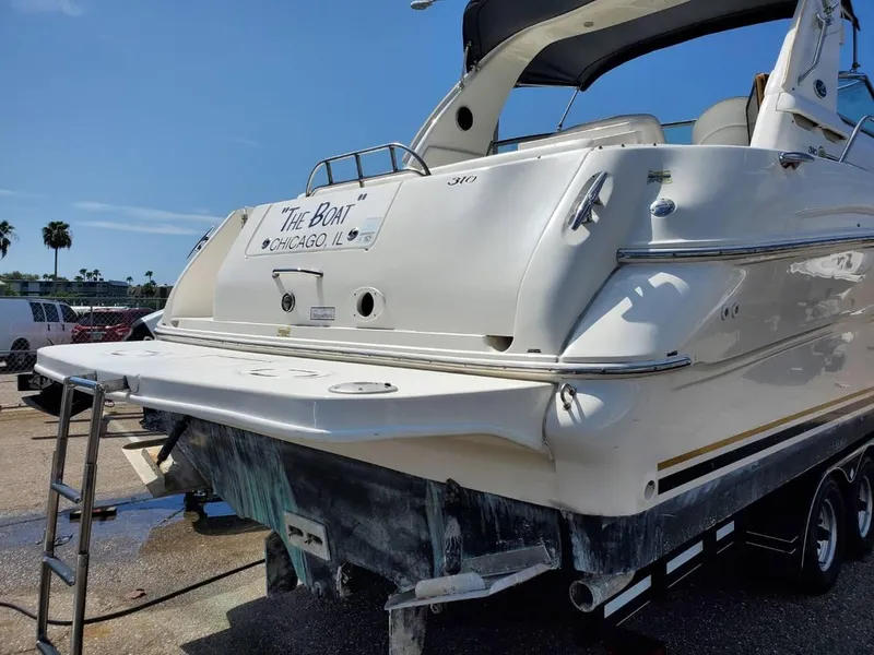 Slide: The Image of 2002 Sea Ray 310 Sundancer boat on trailer, rear view, sunny day. - 5