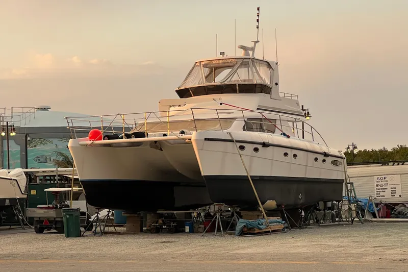 Slide: The Image of 2009 Africat Marine 420 yacht on dry dock at sunset, undergoing maintenance. - 15
