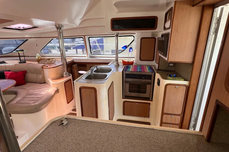 Slide: The Image of Interior of a 2009 Africat Marine 420 yacht with kitchen and seating area. - 19