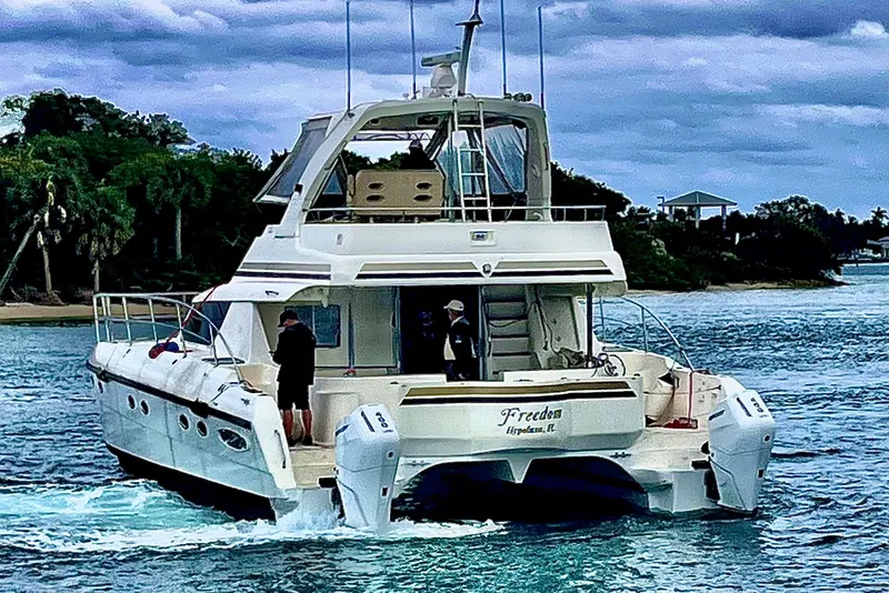 Slide: The Image of 2009 Africat Marine 420 yacht cruising on a scenic waterway. - 2