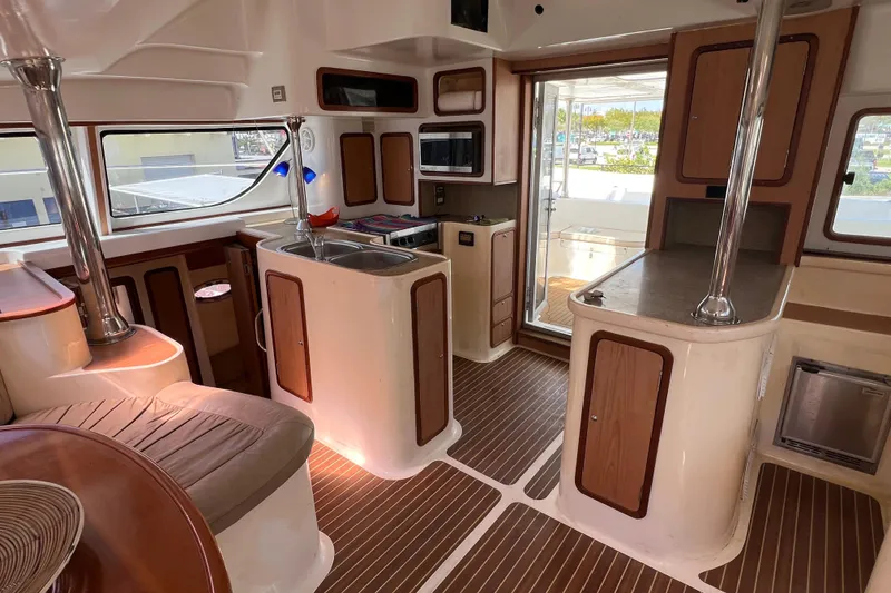 Slide: The Image of Luxurious 2009 Africat Marine 420 yacht interior with modern kitchen and elegant wood finishes. - 21