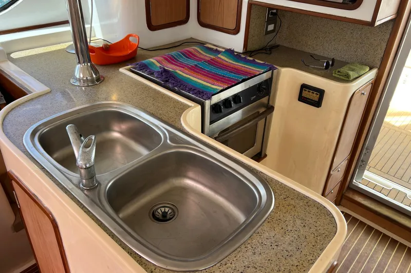 Slide: The Image of 2009 Africat Marine 420 yacht kitchen with dual sink, stove, and countertop. - 27