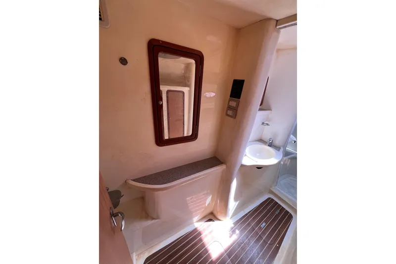 Slide: The Image of Bathroom interior of 2009 Africat Marine 420 yacht, featuring a mirror, sink, and wooden flooring. - 30