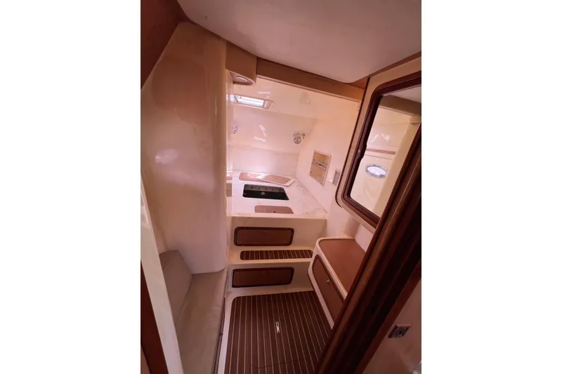 Slide: The Image of Interior of 2009 Africat Marine 420 yacht, featuring compact kitchen area with wooden accents. - 31