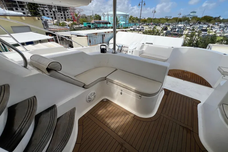 Slide: The Image of Luxurious seating area on 2009 Africat Marine 420 yacht with wooden deck and scenic marina view. - 36
