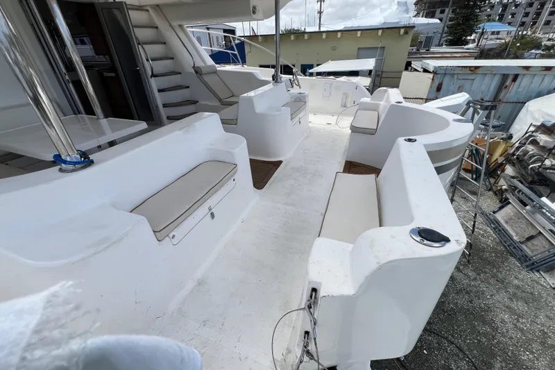 Slide: The Image of 2009 Africat Marine 420 yacht deck with seating and stairs, docked outdoors. - 38