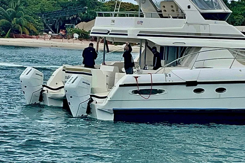 Slide: The Image of Luxury Africat Marine 420 yacht from 2009 on water near tropical beach. - 4