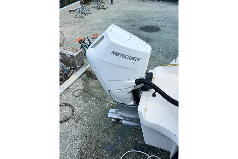 Slide: The Image of Mercury outboard motor on Africat Marine 420, 2009 model, in a boatyard setting. - 41