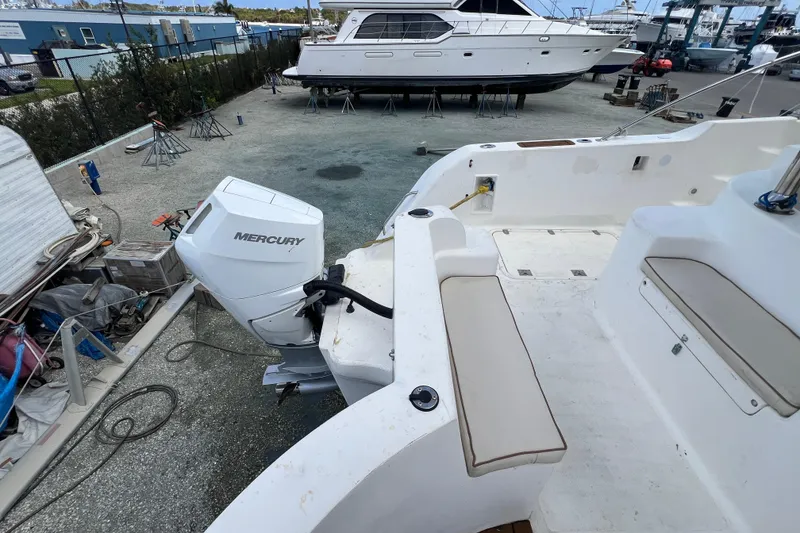 Slide: The Image of 2009 Africat Marine 420 boat with Mercury outboard motor in a shipyard setting. - 42