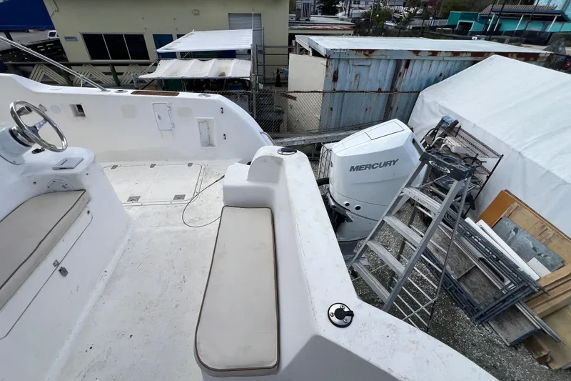 Slide: The Image of 2009 Africat Marine 420 boat deck with Mercury outboard motor in a storage area. - 43