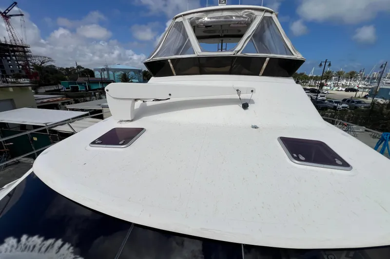 Slide: The Image of 2009 Africat Marine 420 yacht deck with hatches, marina background, partly cloudy sky. - 48