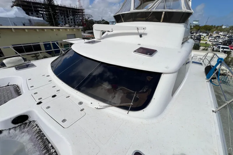 Slide: The Image of 2009 Africat Marine 420 yacht with sleek design, docked near construction site. - 49