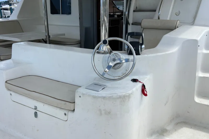 Slide: The Image of Steering area of a 2009 Africat Marine 420 yacht, featuring a sleek design and comfortable seating. - 53