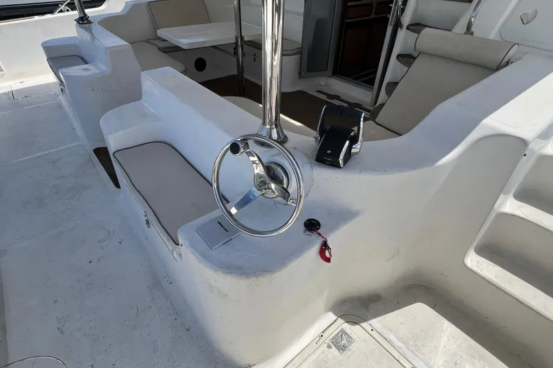 Slide: The Image of Cockpit of 2009 Africat Marine 420 yacht with steering wheel and seating area. - 55