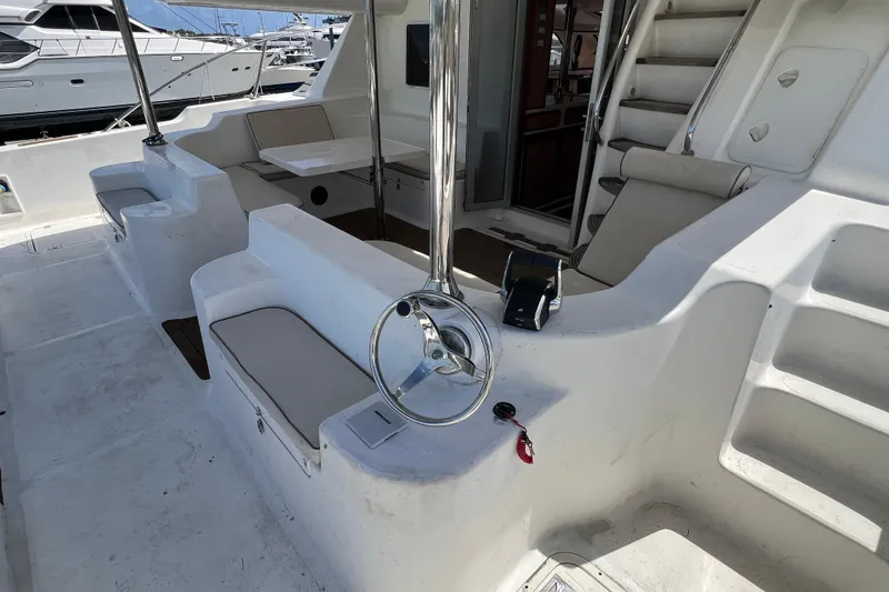 Slide: The Image of 2009 Africat Marine 420 yacht cockpit with seating, steering wheel, and table. - 56