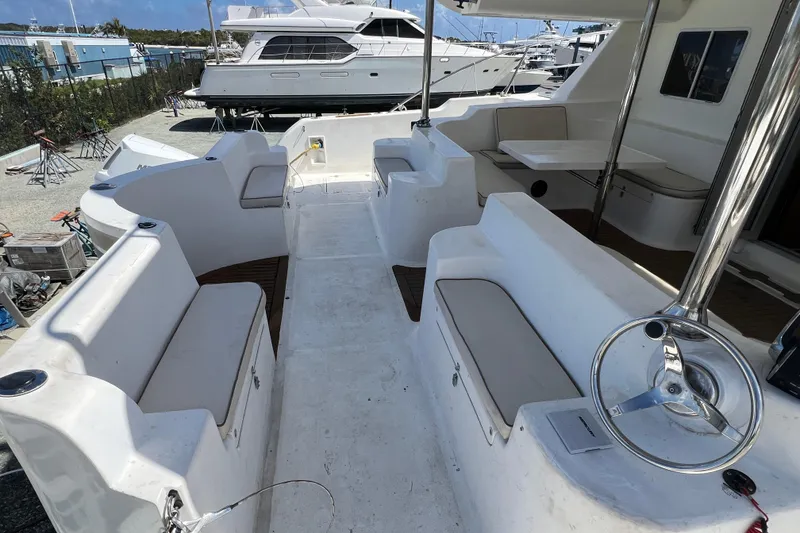 Slide: The Image of 2009 Africat Marine 420 yacht interior with seating and steering wheel, docked at marina. - 57