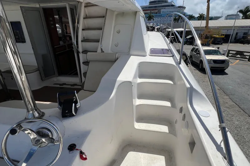Slide: The Image of 2009 Africat Marine 420 yacht deck with steering wheel and seating area. - 58