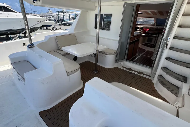 Slide: The Image of 2009 Africat Marine 420 yacht interior with seating area, table, and stairs. - 59