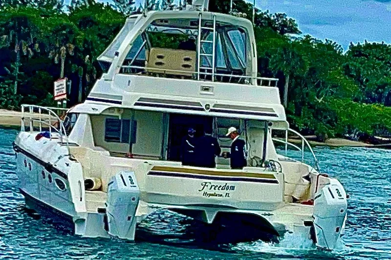 Slide: The Image of Africat Marine 420 yacht cruising near lush shoreline, 2009 model. - 6