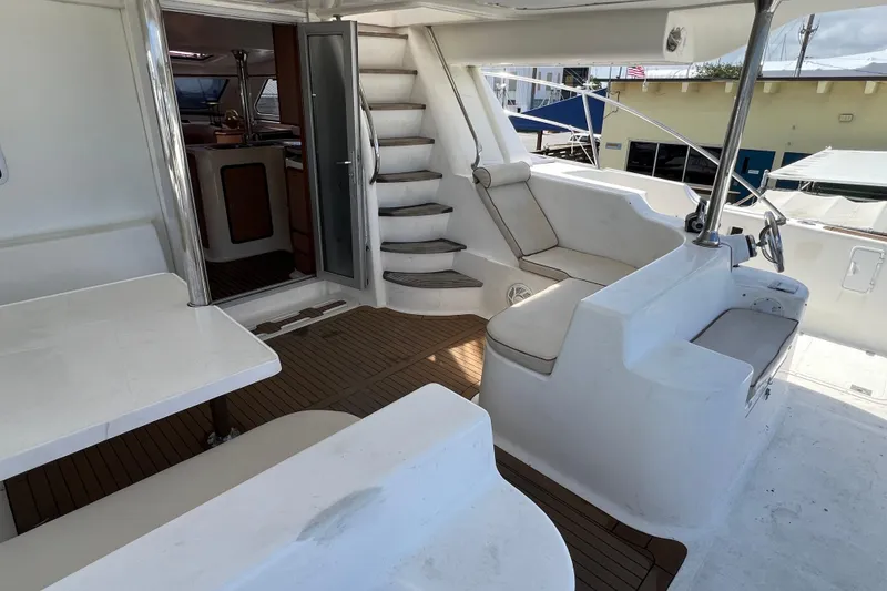 Slide: The Image of 2009 Africat Marine 420 yacht interior with seating, stairs, and wooden flooring. - 60