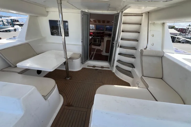 Slide: The Image of 2009 Africat Marine 420 yacht interior with seating, table, and stairs. - 63