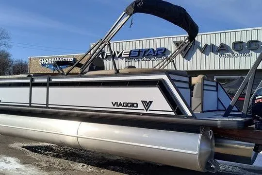 Slide: The Image of 2026 Viaggio V22U pontoon boat displayed outside dealership. - 4