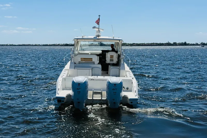 Slide: The Image of 2021 Pursuit OS 355 Offshore boat cruising on open water. - 12