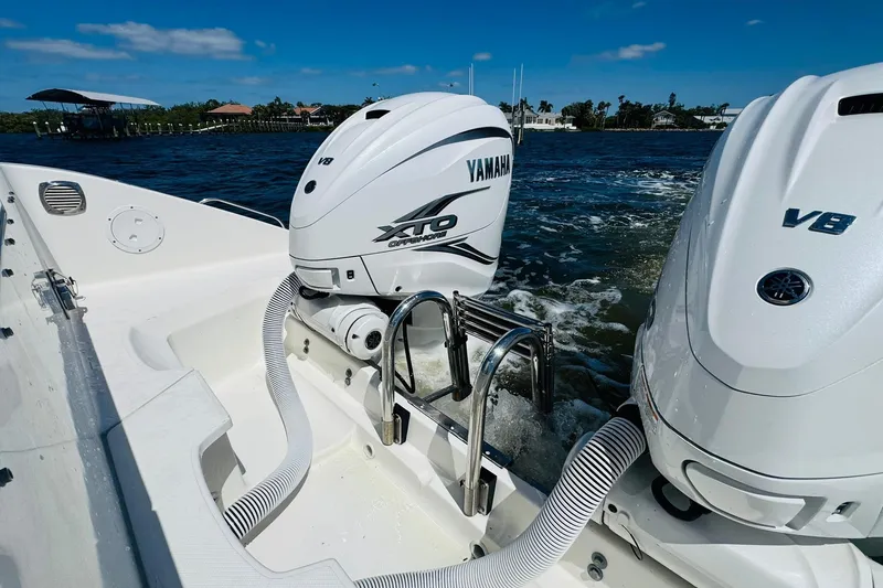 Slide: The Image of 2021 Pursuit OS 355 Offshore boat with Yamaha XTO V8 engines on water. - 16