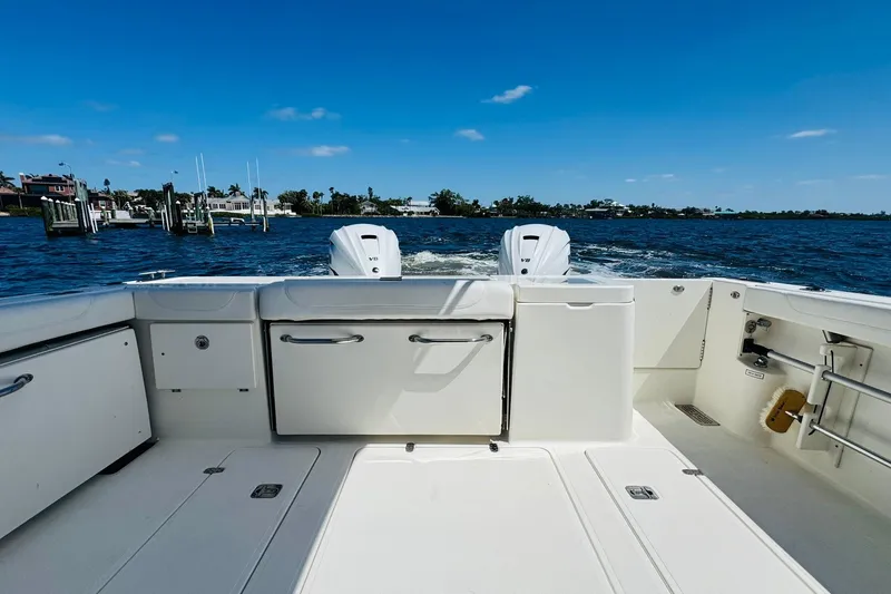 Slide: The Image of 2021 Pursuit OS 355 Offshore boat on water, clear sky, rear view. - 20