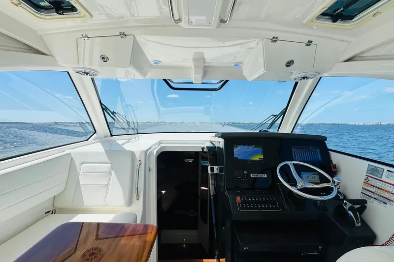 Slide: The Image of Interior view of 2021 Pursuit OS 355 Offshore boat cockpit with navigation equipment. - 27