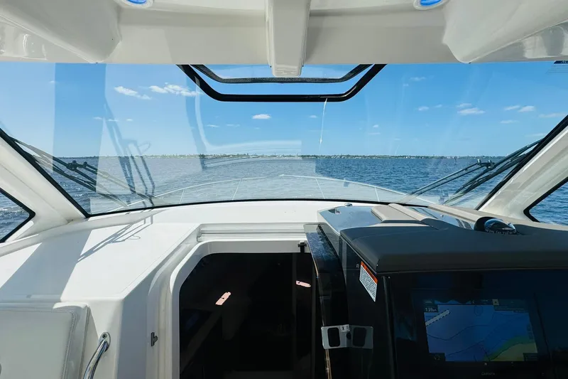 Slide: The Image of Interior view of 2021 Pursuit OS 355 Offshore boat cockpit with ocean horizon. - 30